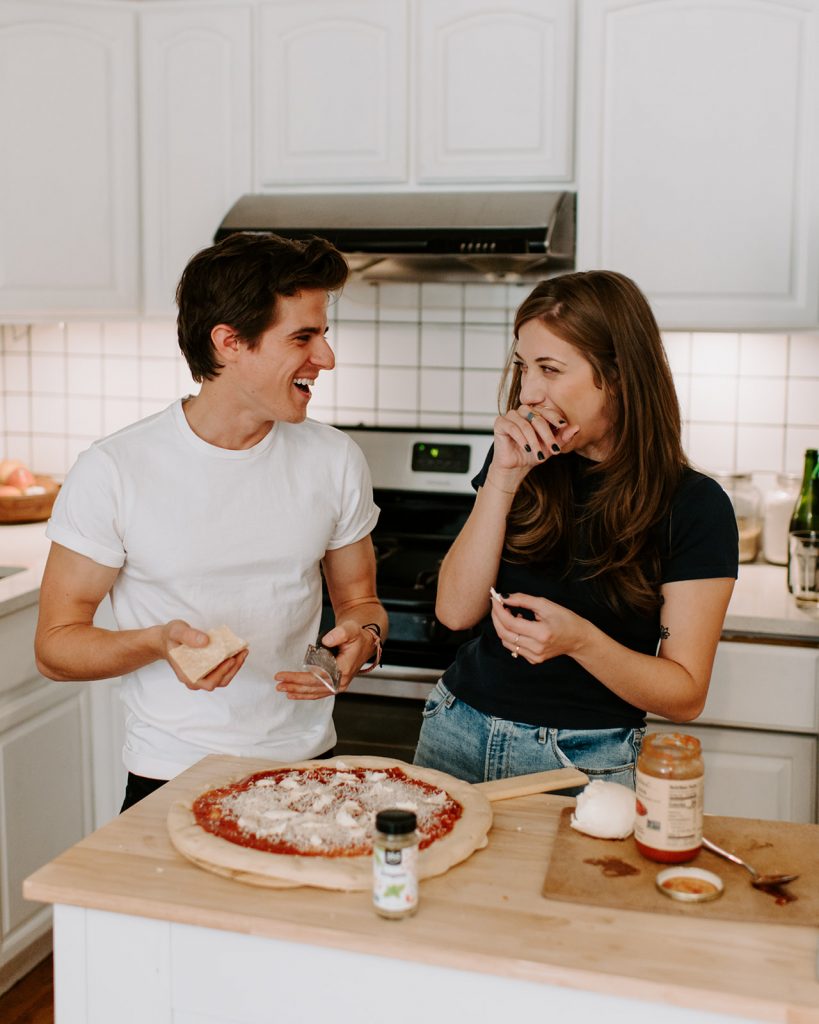 intimate engagement session in williamsburg brooklyn couple making homemade pizza